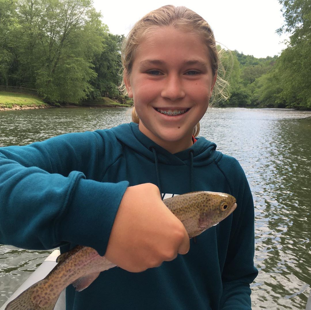 Young Girl Holding Small Fish